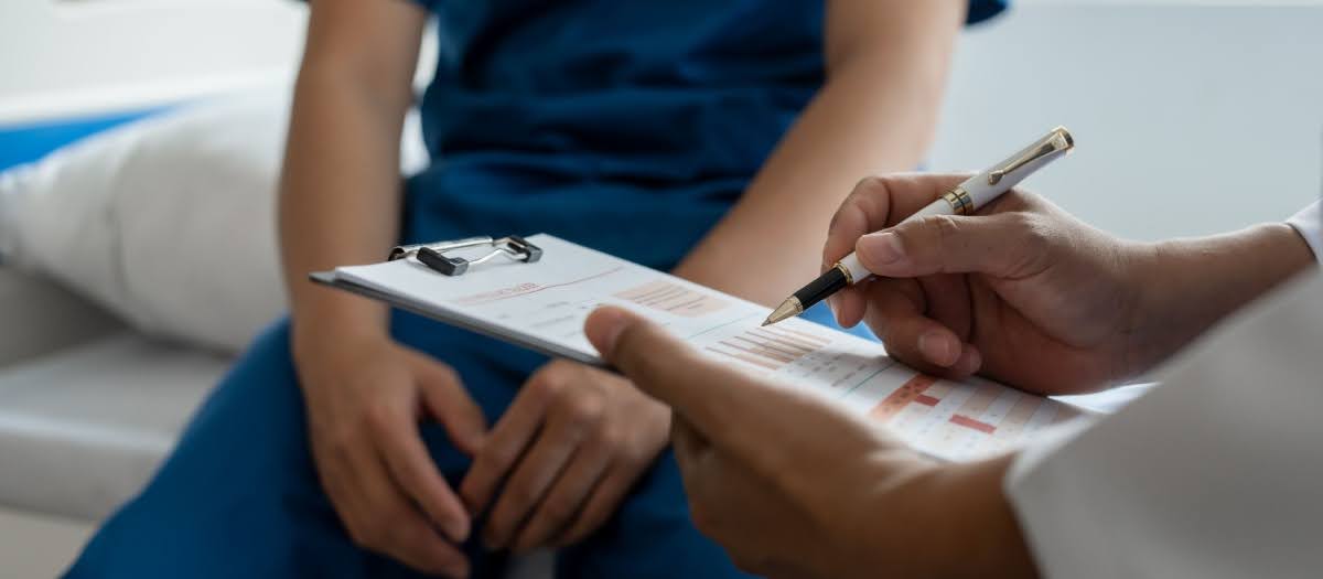 Young male patient sitting in the doctor's office, getting ready to be tested for STDs