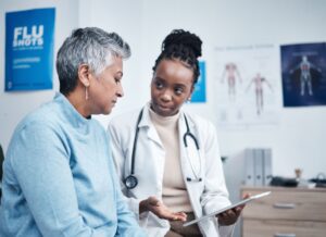 A doctor explaining the options for preventative health screenings to an elderly woman